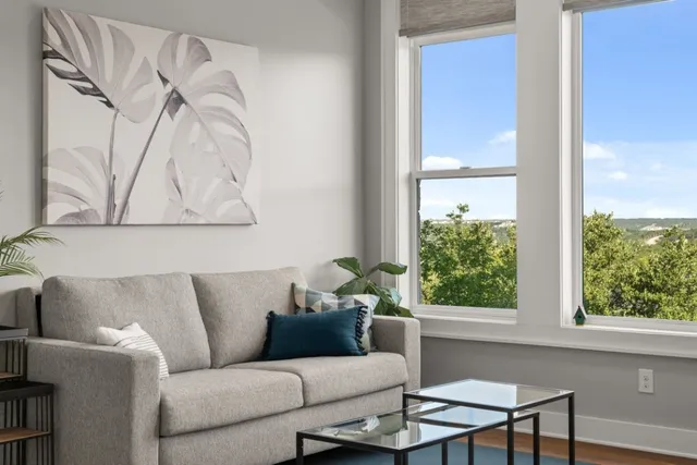 a living room with furniture fireplace and flat screen tv