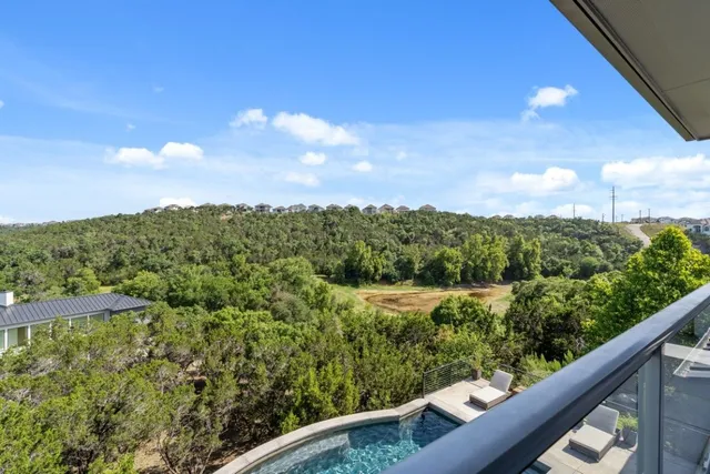 a view of a house with swimming pool and sitting area