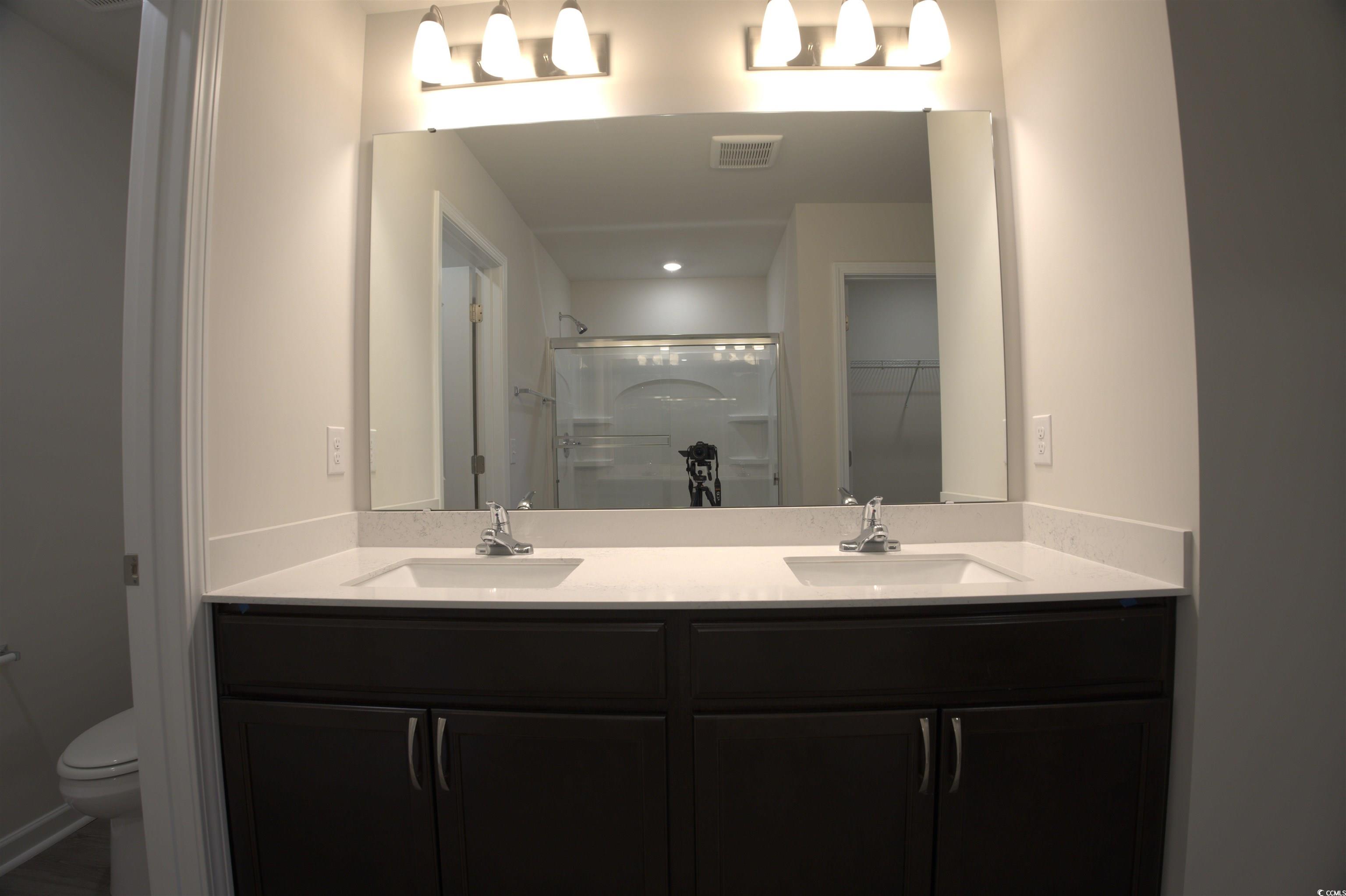 209 Kc Lane Aynor, SC 29511 - Photo 10 of 13 Bathroom with a shower stall, double vanity, and a walk in closet