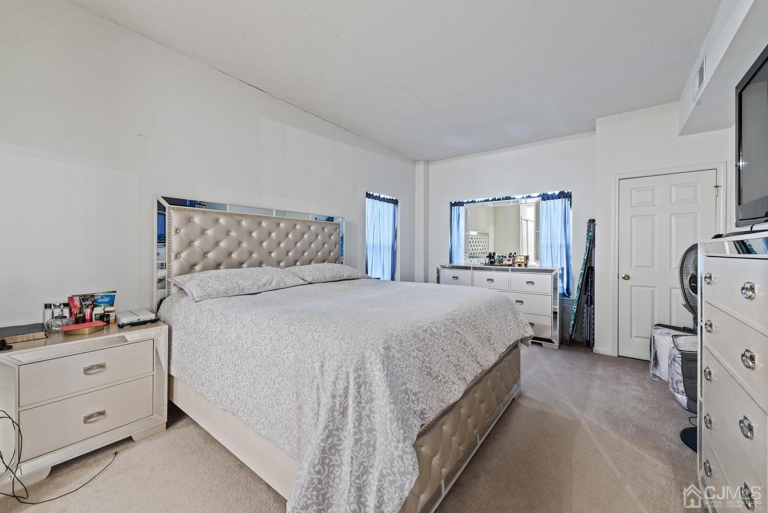 358 Rector Street, Unit 407 Perth Amboy, NJ 08861 - Photo 19 of 28 a bedroom with a bed and a dresser