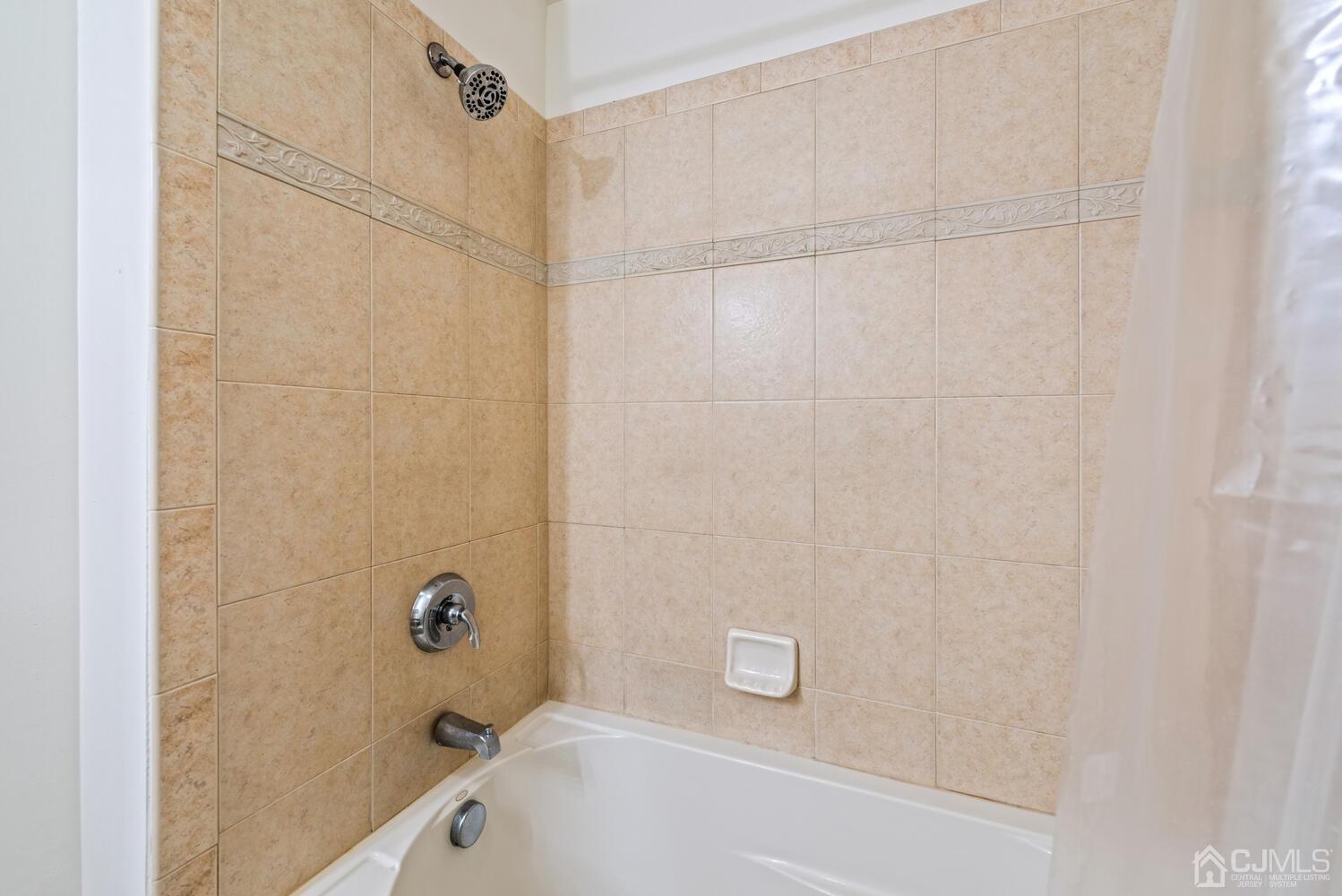 358 Rector Street, Unit 407 Perth Amboy, NJ 08861 - Photo 21 of 28 a bathroom with a bathtub and a shower