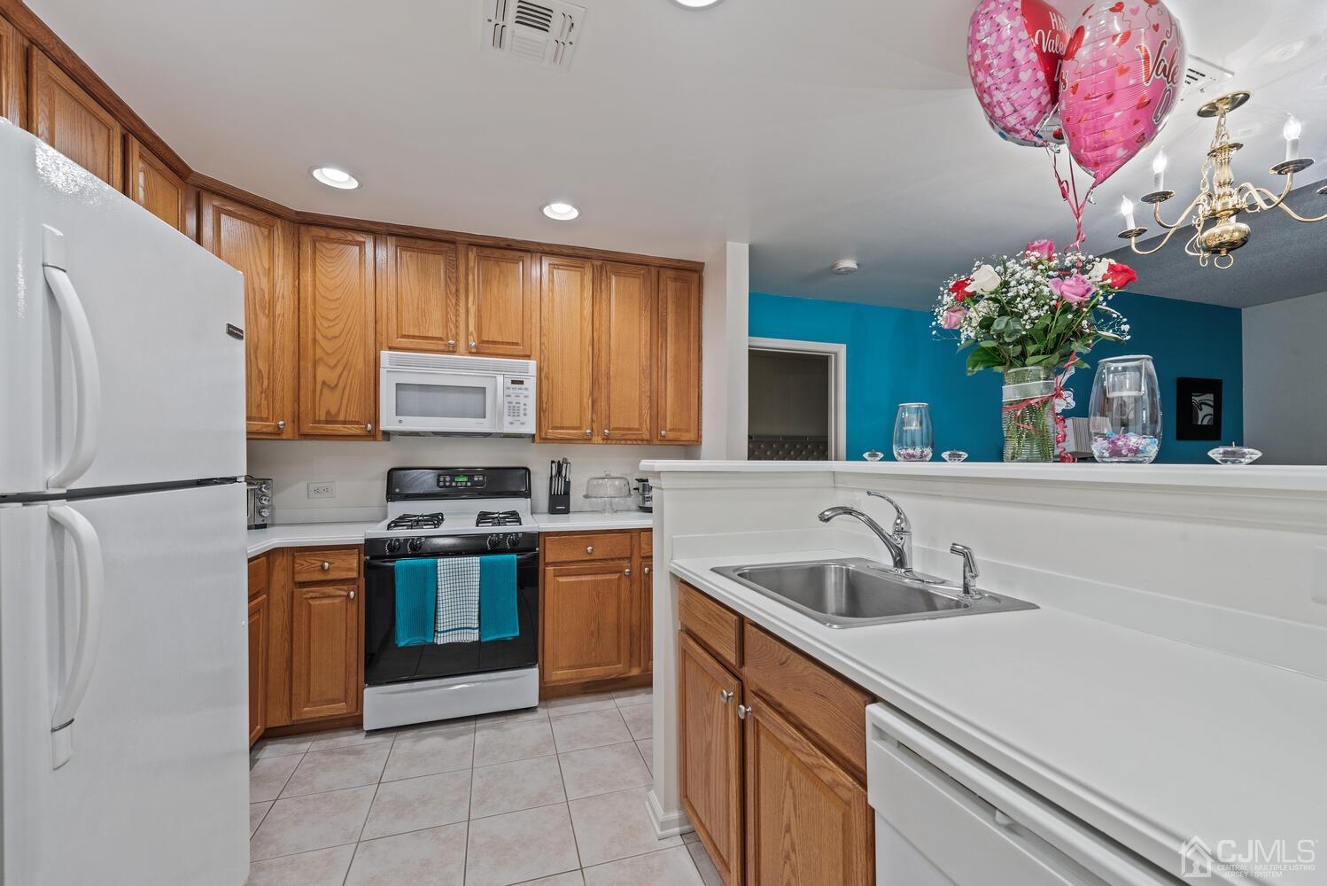 358 Rector Street, Unit 407 Perth Amboy, NJ 08861 - Photo 8 of 28 a kitchen with granite countertop a sink stainless steel appliances and cabinets