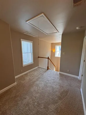 a view of a livingroom with an empty space and a fireplace