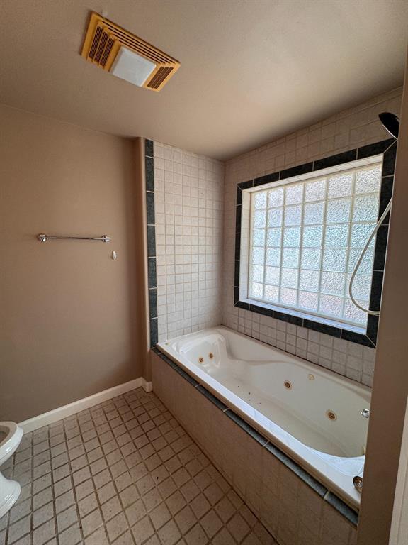 201 West 33rd Street, Unit B Austin, TX 78705 - Photo 18 of 27 a bathroom with a bathtub and a shower