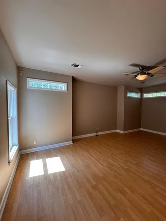 a view of a livingroom with a ceiling fan and window