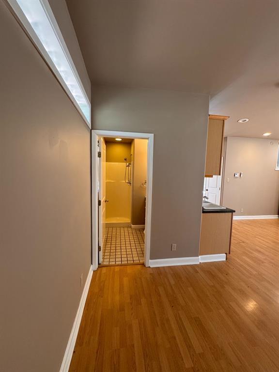201 West 33rd Street, Unit B Austin, TX 78705 - Photo 7 of 27 a view of an empty room with wooden floor and a window