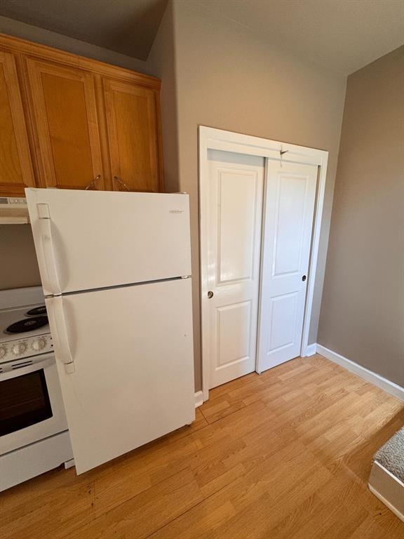 201 West 33rd Street, Unit B Austin, TX 78705 - Photo 9 of 27 a view of a refrigerator in kitchen and wooden floor