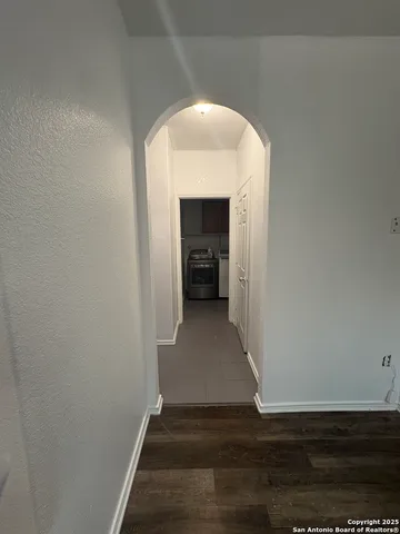 a view of a hallway view with wooden floor and staircase