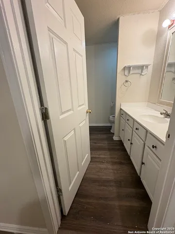 a bathroom with a sink a toilet and a mirror