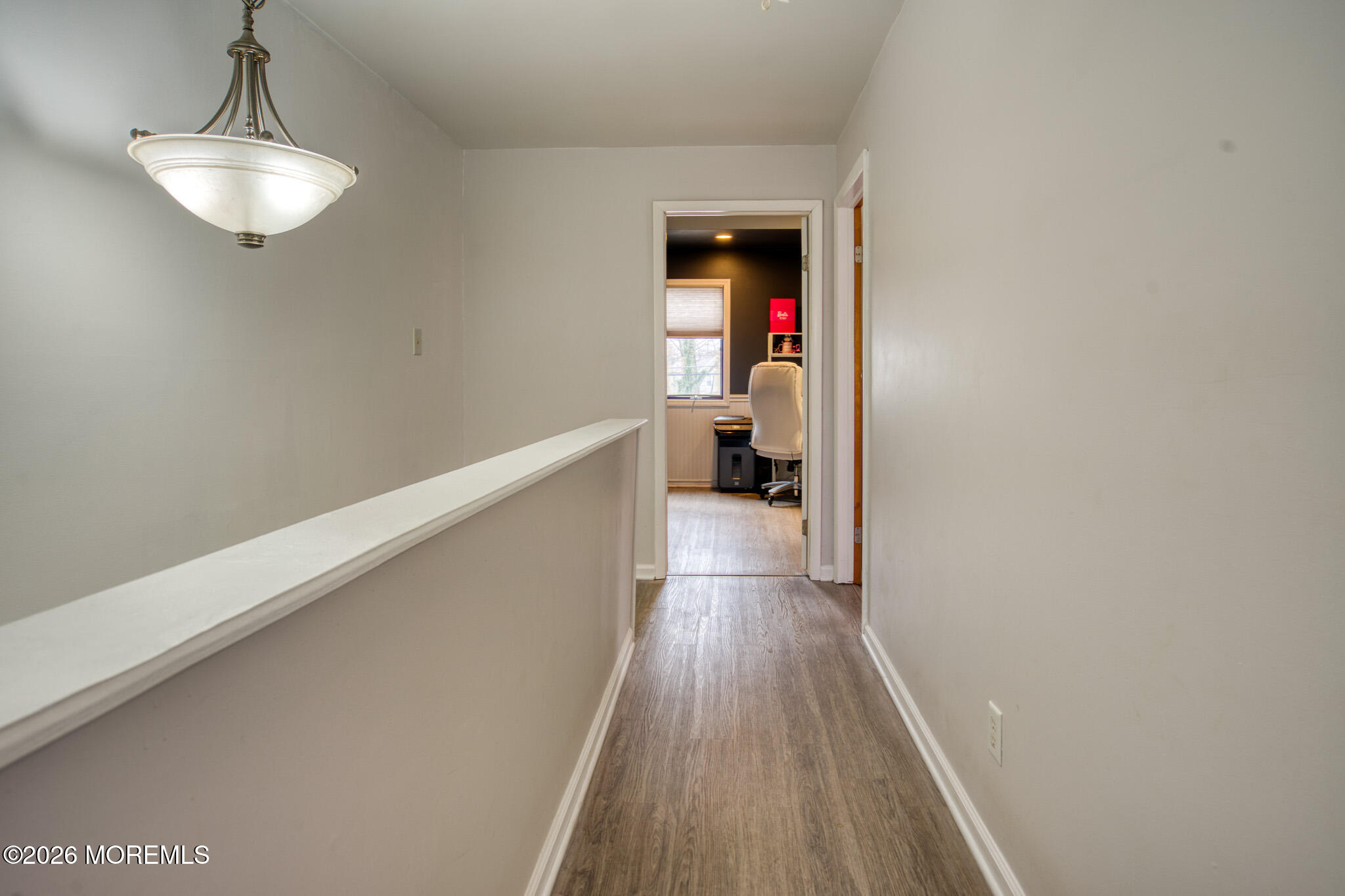 138 3rd Street Keyport, NJ 07735 - Photo 12 of 20 a hallway with wooden floor closet and a chandelier