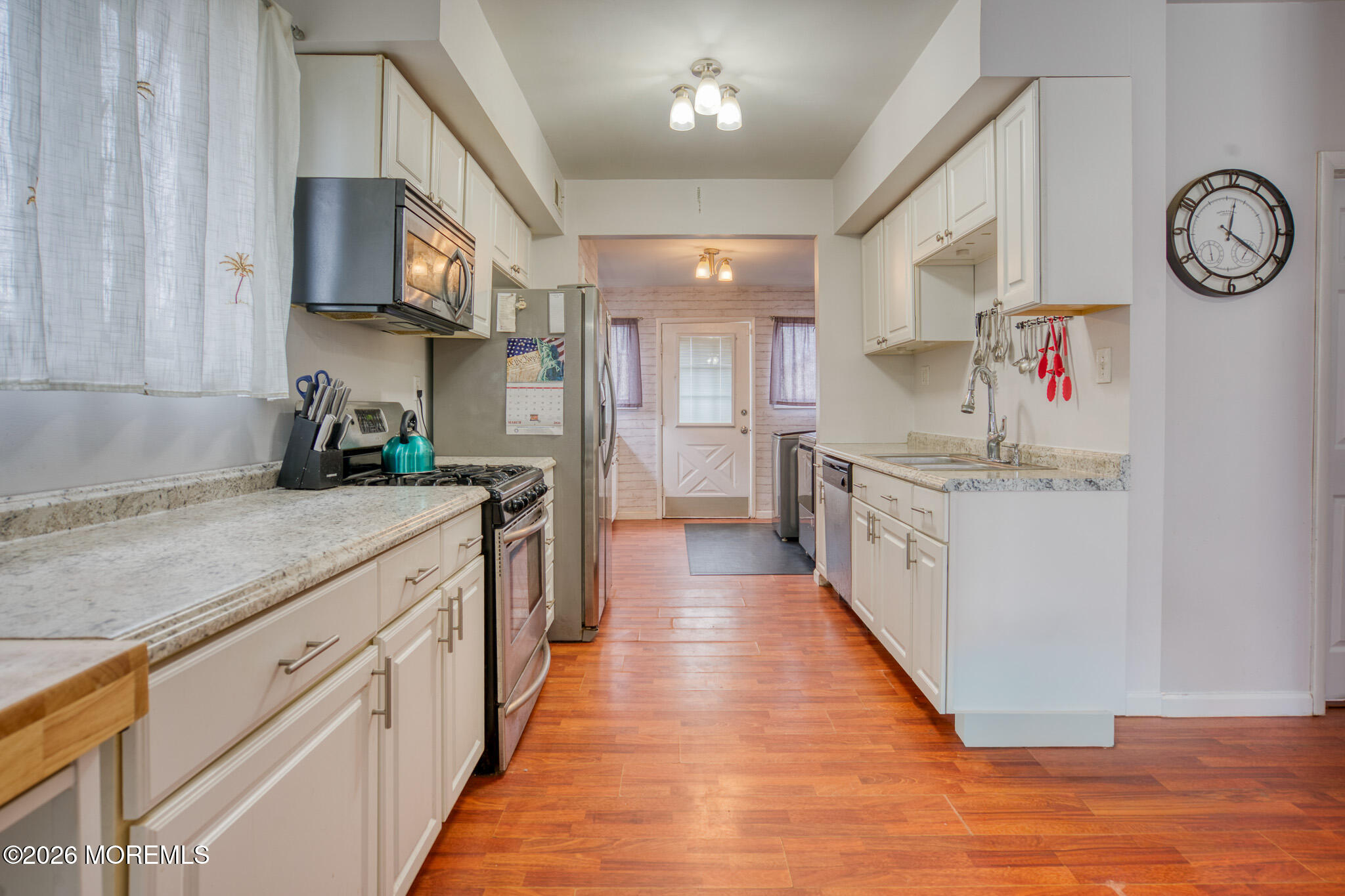 138 3rd Street Keyport, NJ 07735 - Photo 8 of 20 a kitchen with cabinets and wooden floor