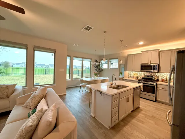 a large bed sitting in a bedroom next to a window