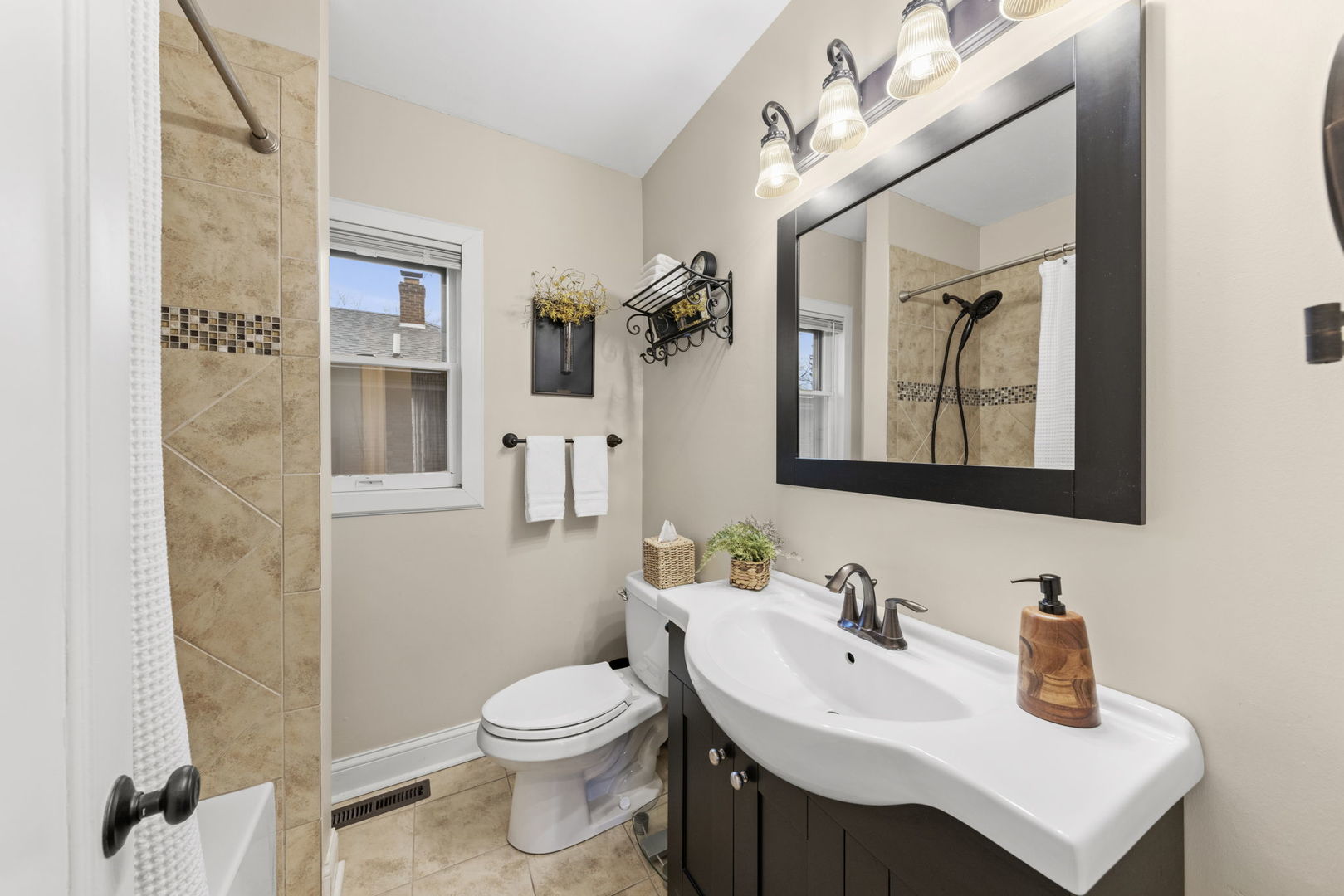 909 Webster Avenue Wheaton, IL 60187 - Photo 13 of 27 a bathroom with a toilet sink and mirror