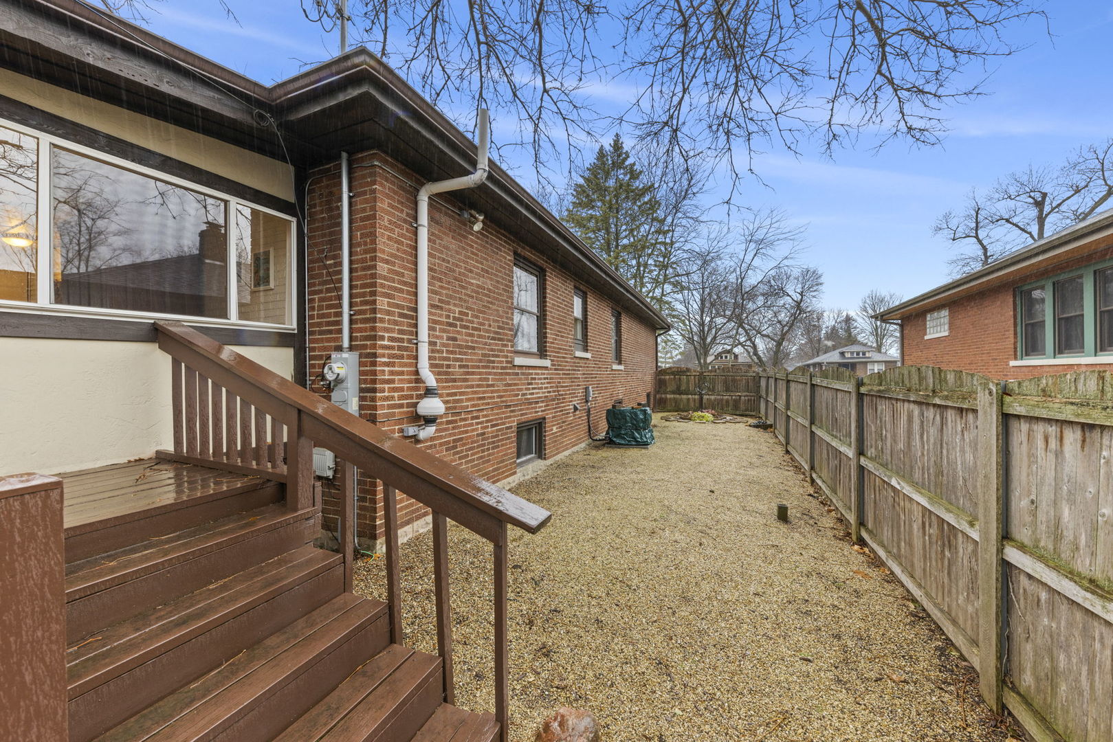 909 Webster Avenue Wheaton, IL 60187 - Photo 21 of 27 a view of a house with wooden stairs and a small yard