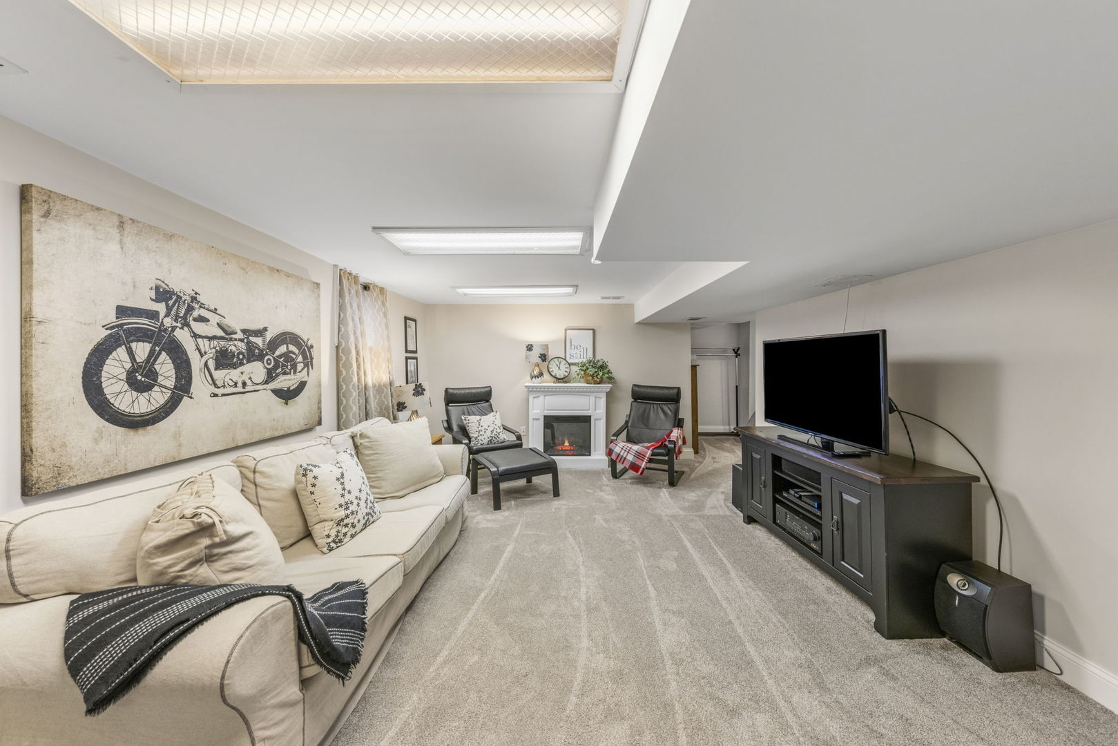 909 Webster Avenue Wheaton, IL 60187 - Photo 24 of 27 a living room with furniture and a flat screen tv