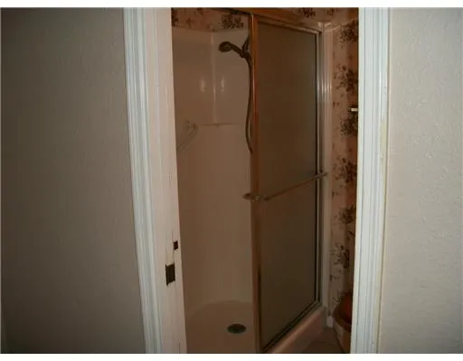 a bathroom with a glass shower door