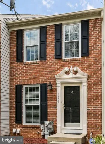 a view of a brick house with a large window