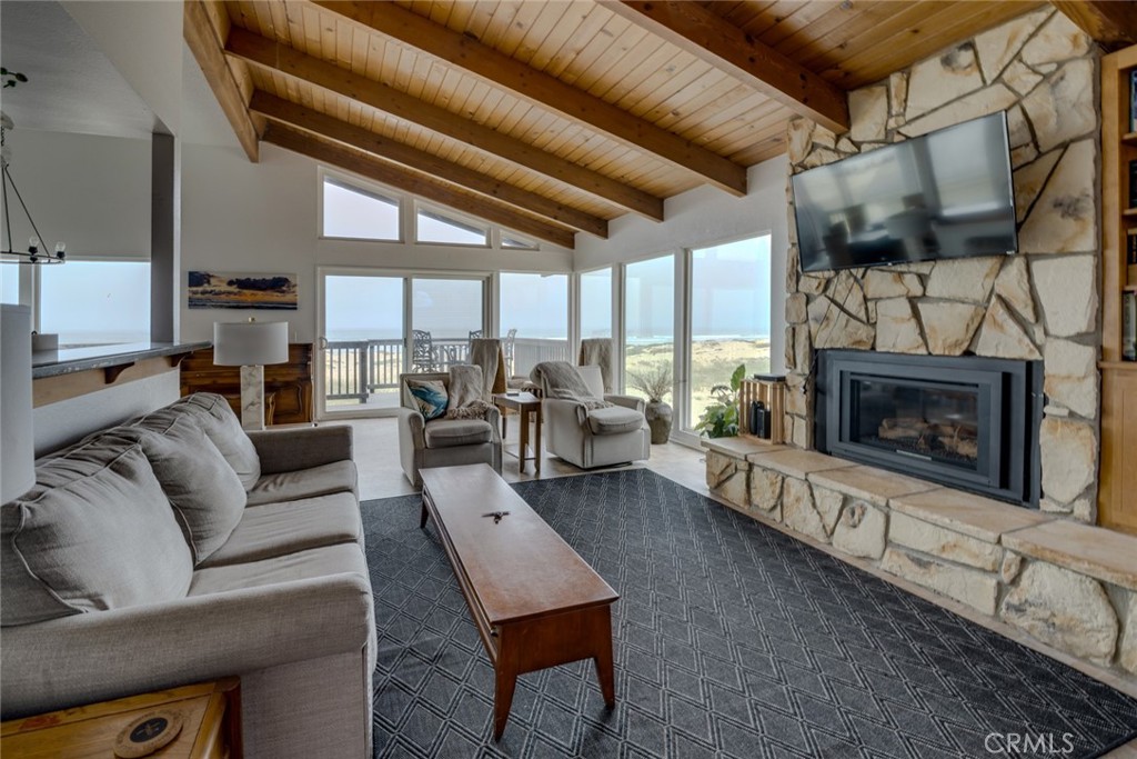 1612 Strand Way Oceano, CA 93445 - Photo 12 of 27 a living room with furniture a large window and a fireplace
