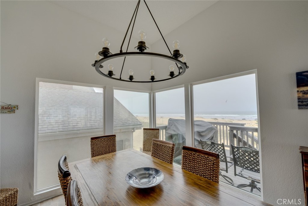 1612 Strand Way Oceano, CA 93445 - Photo 13 of 27 a view of a dining room with furniture window and wooden floor