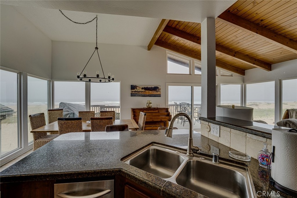 1612 Strand Way Oceano, CA 93445 - Photo 14 of 27 a kitchen with a sink a counter top space appliances and cabinets