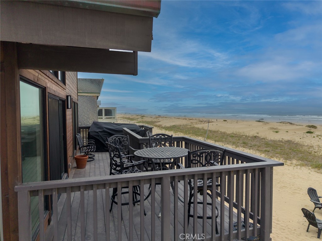 1612 Strand Way Oceano, CA 93445 - Photo 22 of 27 a view of a balcony with furniture and wooden floor