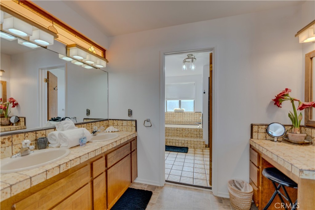 1612 Strand Way Oceano, CA 93445 - Photo 5 of 27 a spacious bathroom with a granite countertop sink and a mirror