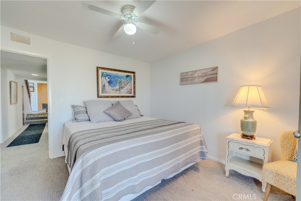 1612 Strand Way Oceano, CA 93445 - Photo 6 of 27 a bed room with a bed and a lamp