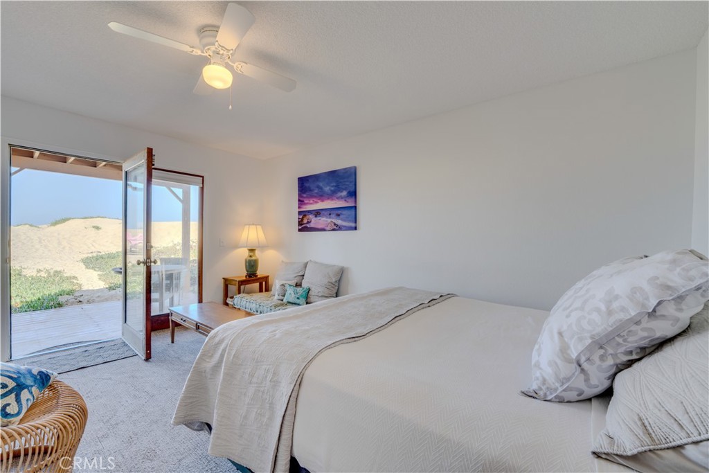 1612 Strand Way Oceano, CA 93445 - Photo 7 of 27 a bedroom with a balcony a bed and a large window with the outer view