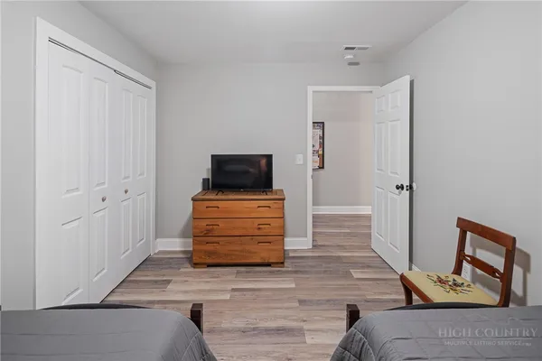a bedroom with two beds and window