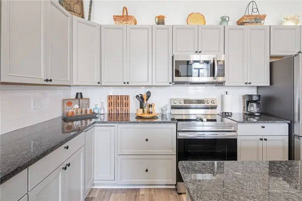a kitchen with stainless steel appliances a sink stove and refrigerator