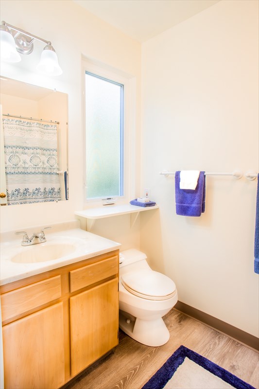 5001 Kikala Road, Unit 1 Kalaheo, HI 96741 - Photo 11 of 14 a bathroom with a toilet sink and mirror