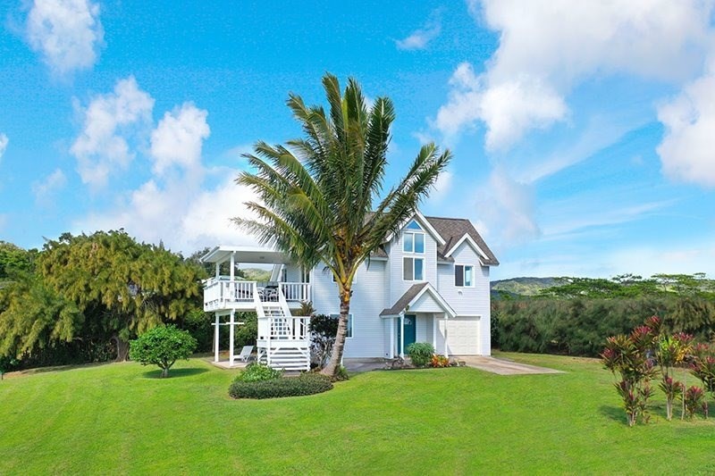 5001 Kikala Road, Unit 1 Kalaheo, HI 96741 - Photo 14 of 14 a front view of a house with a yard garage and outdoor seating