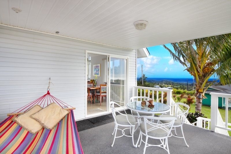 5001 Kikala Road, Unit 1 Kalaheo, HI 96741 - Photo 3 of 14 a dining room with furniture and a floor to ceiling window
