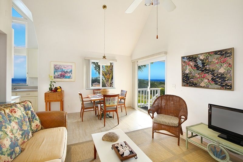 5001 Kikala Road, Unit 1 Kalaheo, HI 96741 - Photo 4 of 14 a living room with furniture a dining table and a piano next to a window