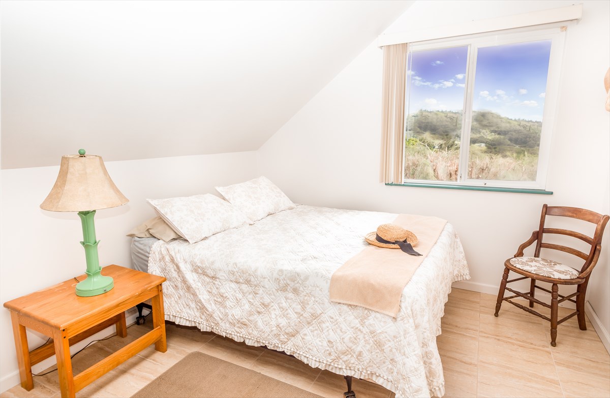 5001 Kikala Road, Unit 1 Kalaheo, HI 96741 - Photo 8 of 14 a bedroom with a bed and a lamp on table