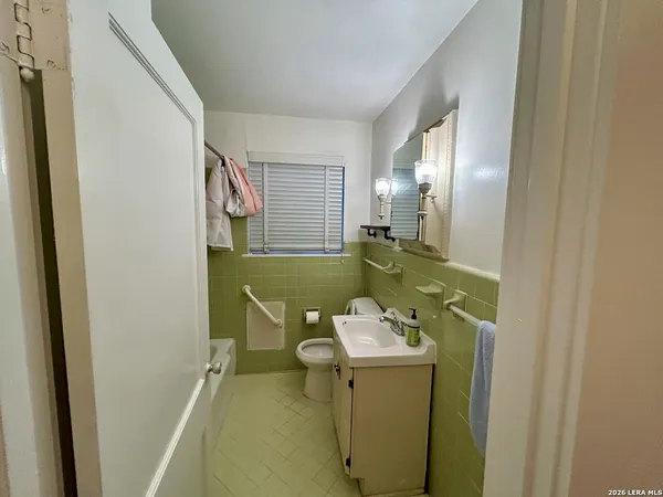 a bathroom with a sink toilet and mirror