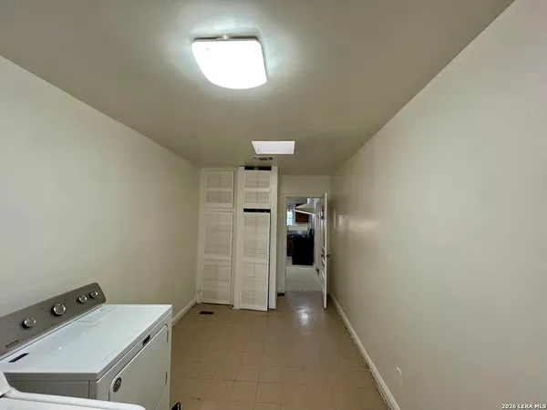 a view of a storage & utility room with a sink