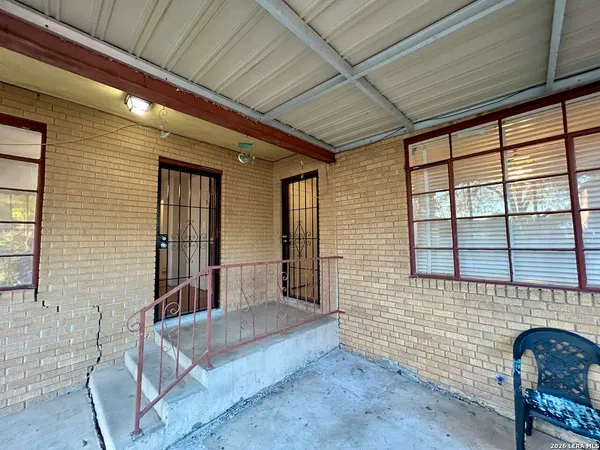 a view of front door of house with outdoor seating