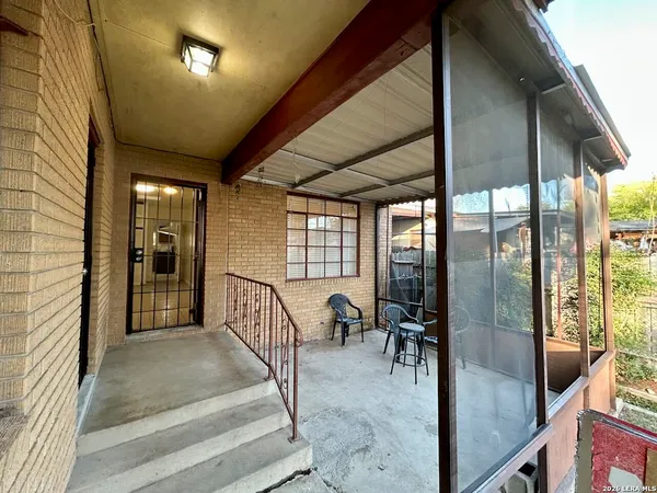 a view of a livingroom with furniture and floor to ceiling window
