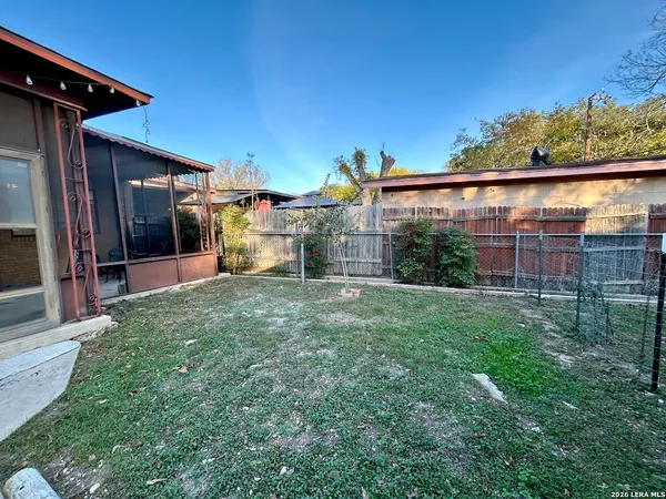 a view of a backyard with plants and a patio