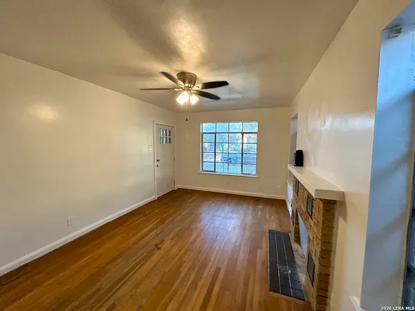 wooden floor in an empty room with a window