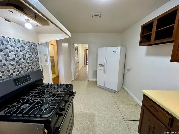a kitchen with a stove and a refrigerator