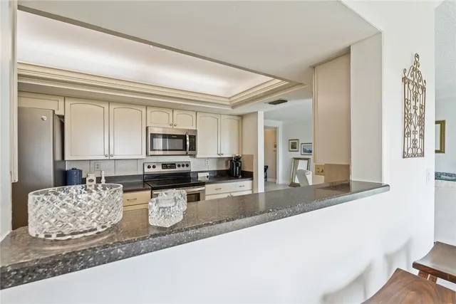 a large kitchen with granite countertop a sink and a stove top oven with granite countertops