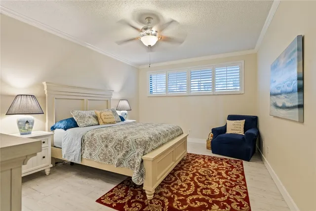 a bedroom with a bed and a lamp with the dresser