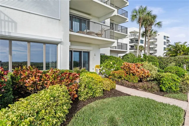 a view of a chairs and table in back yard of the house