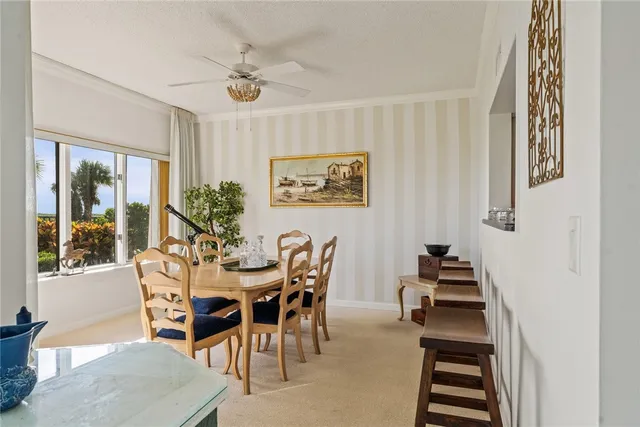 a view of a dining room with furniture and a chandelier
