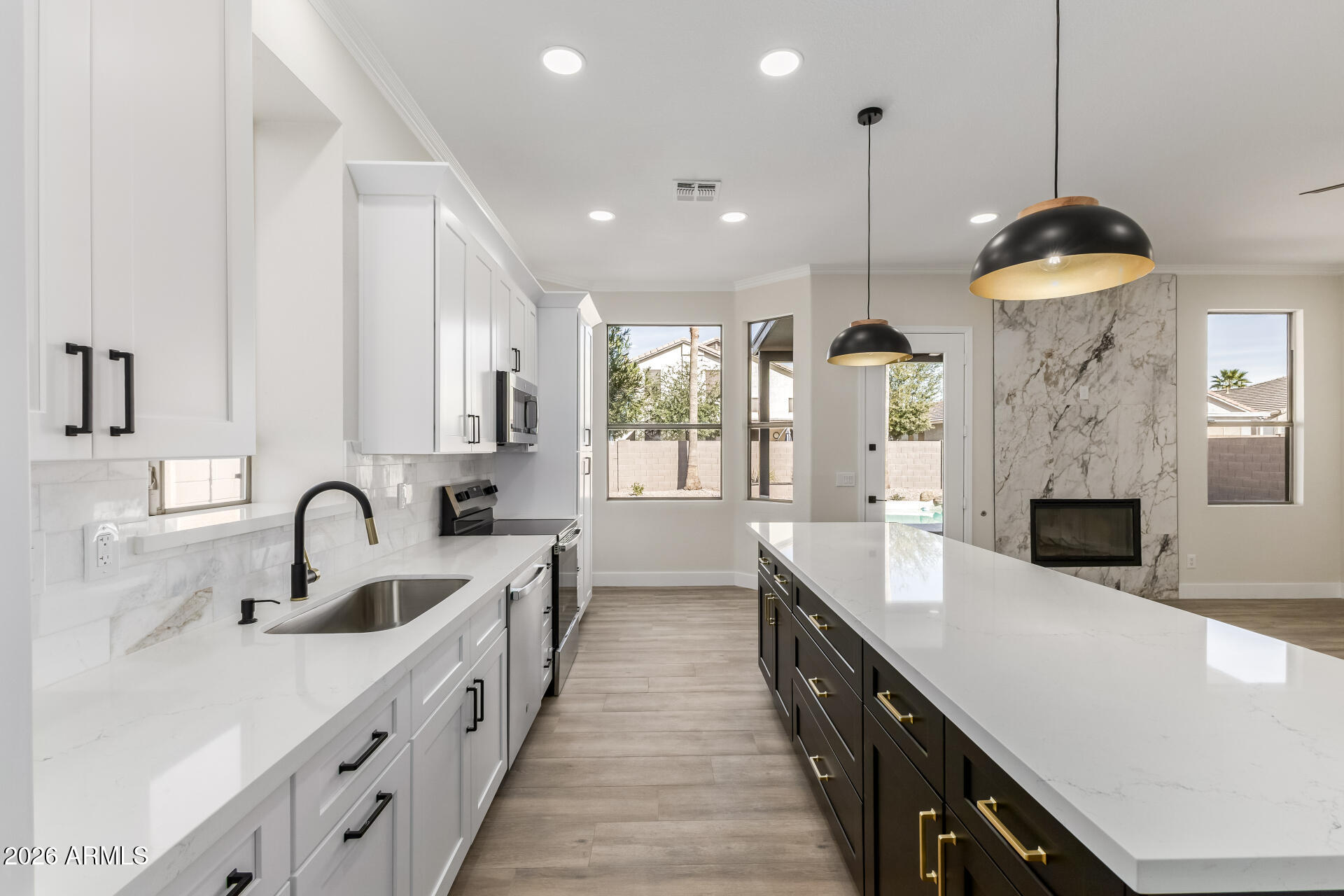 a large kitchen with granite countertop a sink and cabinets
