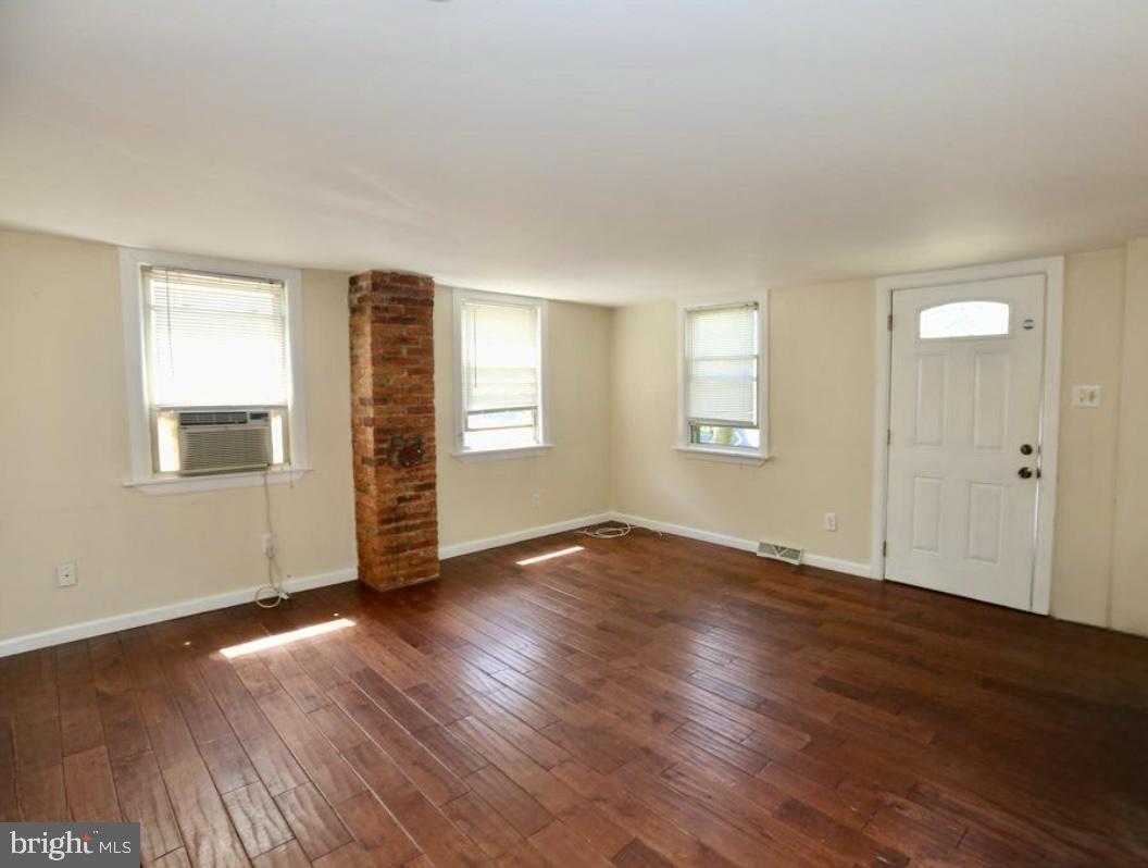 310 Ellis Street Glassboro, NJ 08028 - Photo 13 of 15 an empty room with wooden floor and windows