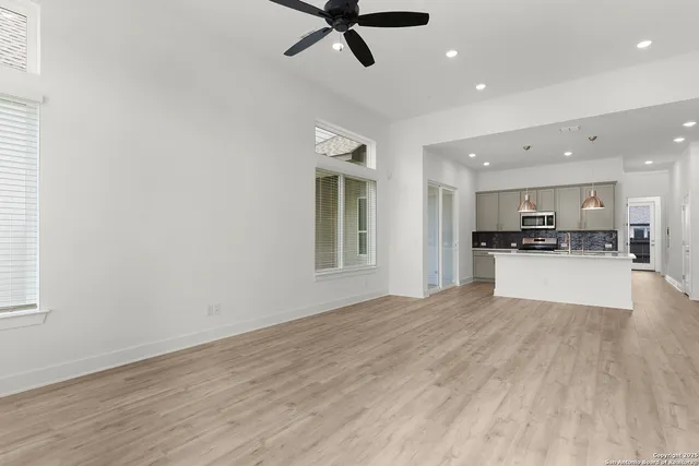 a view of kitchen with refrigerator and window