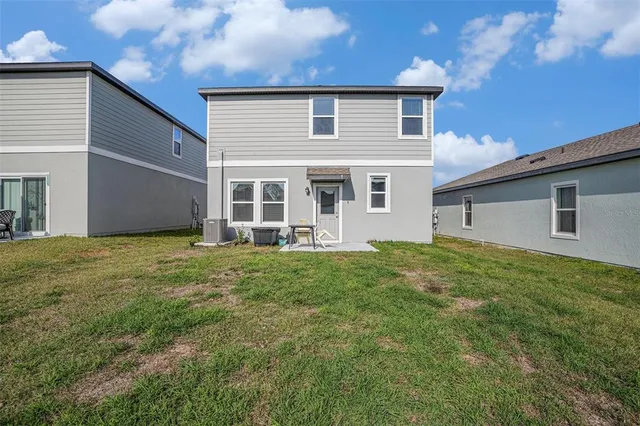 a view of a house with a backyard